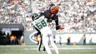 Quincy Williams #56 of the New York Jets tackles Chris Evans #25 of the Cincinnati Bengals after he made a catch during the second half at MetLife Stadium on September 25, 2022 in East Rutherford, New Jersey. (Photo by Sarah Stier/Getty Images)