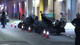 Motorcycles sit parked outside a club where police said a gunman struck four men in Brooklyn.
