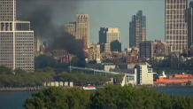 Black smoke fills sky above ferry terminal in Lower Manhattan.