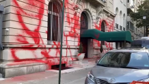 Red spray paint covers the Upper East Side building.