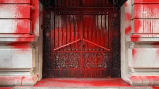 Red spray paint covers the Upper East Side building.