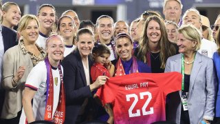 Members of U.S. Soccer, the U.S. Women’s National Team Players Association and other dignitaries pose for a photo after signing a collective bargaining agreement signifying equal pay between the men’s and women’s national soccer teams at Audi Field on September 06, 2022 in Washington, DC.