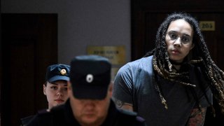 US Women National Basketball Association’s (WNBA) basketball player Brittney Griner, who was detained at Moscow’s Sheremetyevo airport and later charged with illegal possession of cannabis, is escorted to the courtroom to hear the court’s final decision in Khimki outside Moscow, on August 4, 2022.