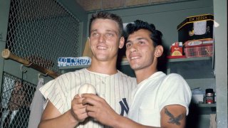 New York Yankees slugger Roger Maris poses with fan Sal Durante in the locker room at Yankee Stadium, Oct. 1, 1961, after hitting his 61st home run of the season.