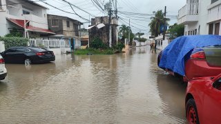 Cars are parked on a flooded street in the aftermath of Hurricane Julia in San Andres island, Colombia, Sunday, Oct.9, 2022.