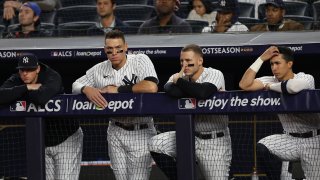 Aaron Judge #99 of the New York Yankees looks on from the dugout during the seventh inning against the Houston Astros in game three of the American League Championship Series at Yankee Stadium on October 22, 2022 in New York City. (Photo by Jamie Squire/Getty Images)
