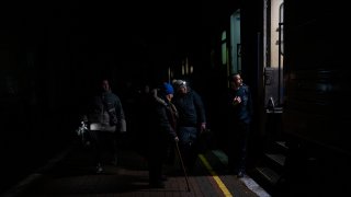 Ukrainians board the Kherson-Kyiv train at the Kherson railway station, southern Ukraine, Saturday, Nov. 26, 2022.