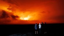 People watch the eruption of Mauna Loa, Monday, Nov. 28, 2022, near Hilo, Hawaii. Mauna Loa, the world's largest active volcano erupted Monday for the first time in 38 years.