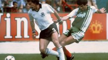 West Germany's Paul Breitner, right, fights for possession with Algerian midfiedler Mustapha Dahleb during the World Cup first round soccer match between West Germany and Algeria on June 16, 1982, in Gijon, Spain. Algeria won over West Germany 2-1. 