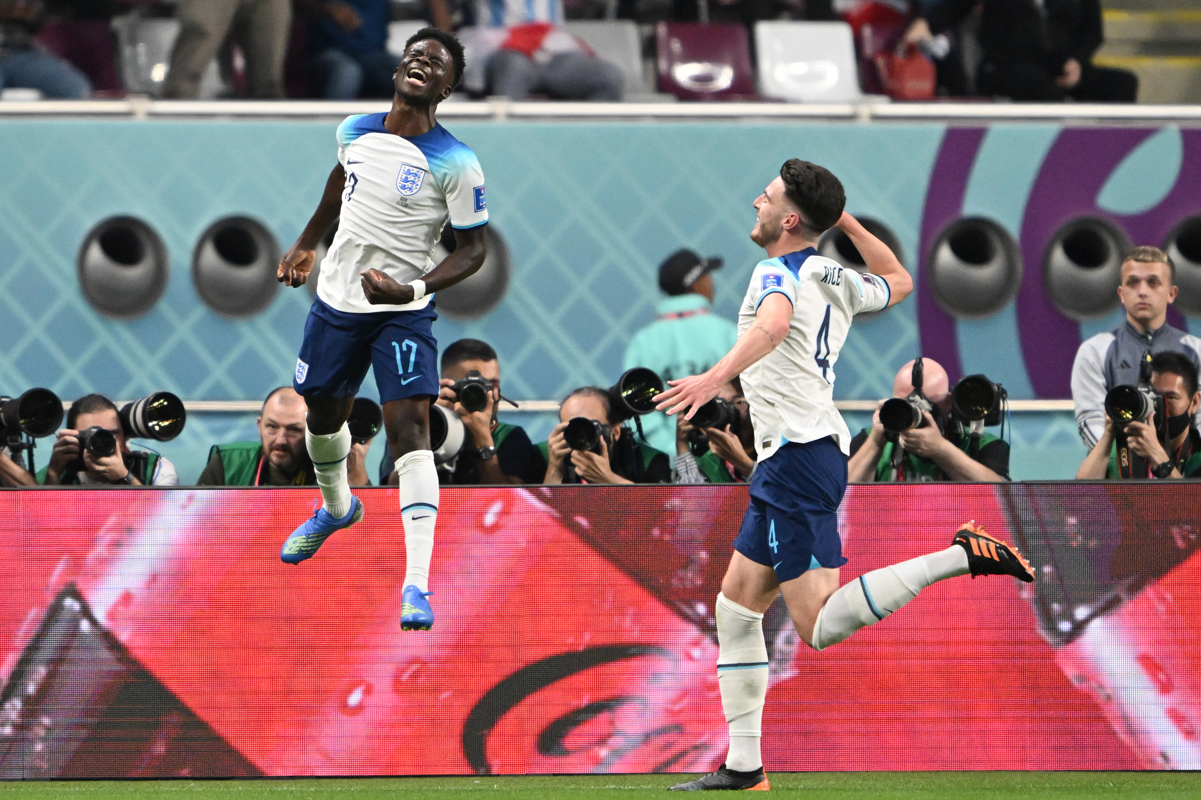 Bukayo Saka, left, celebrates his goal with teammate Declan Rice, Doha, Nov. 21, 2022. Saka put England at 2 – 0 against Iran.