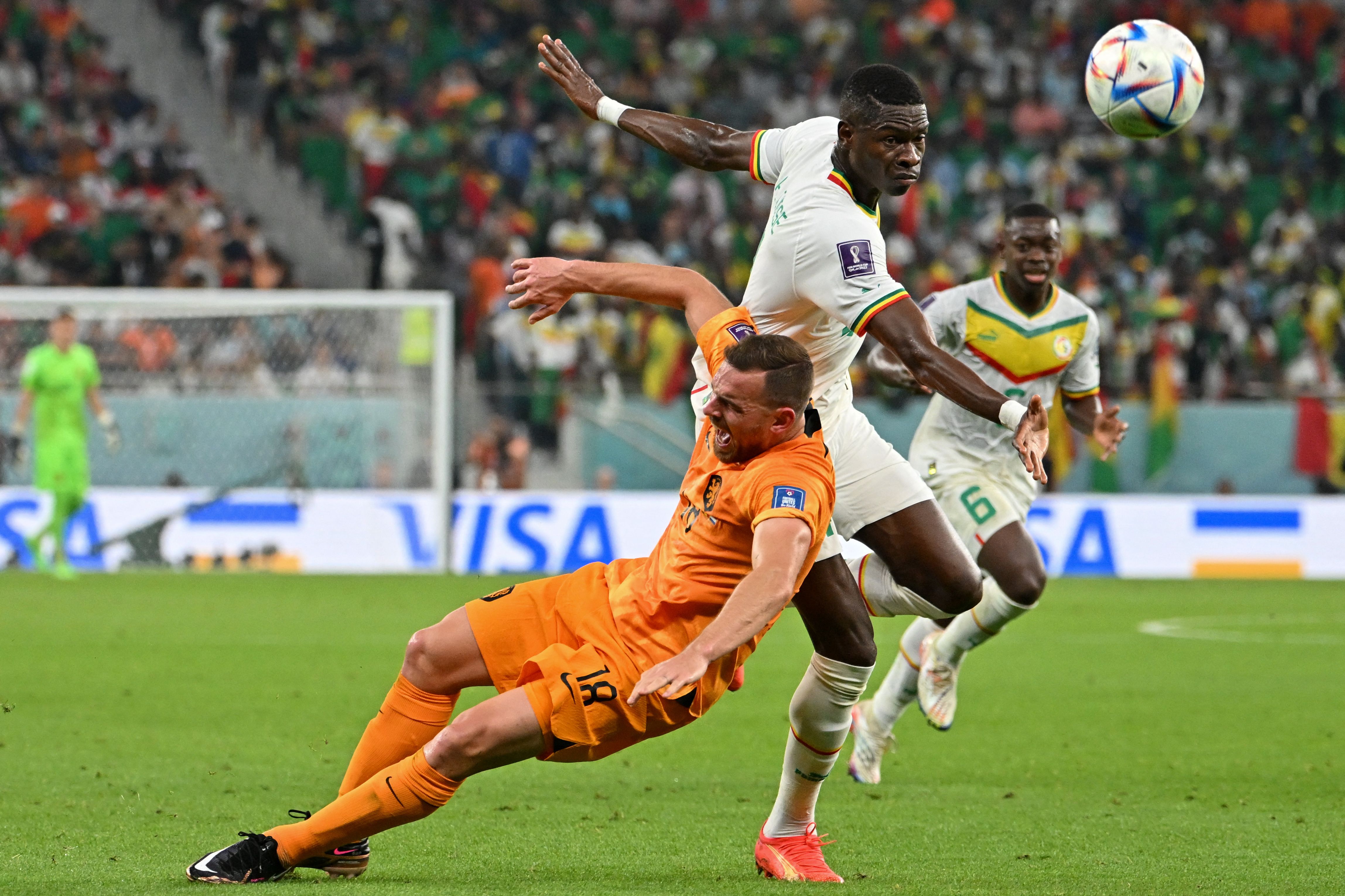 Netherlands’ forward #18 Vincent Janssen (L) and Senegal’s defender #04 Pape Abdou Cisse fight for the ball during the Qatar 2022 World Cup Group A football match between Senegal and the Netherlands at the Al-Thumama Stadium in Doha on Nov. 21, 2022.