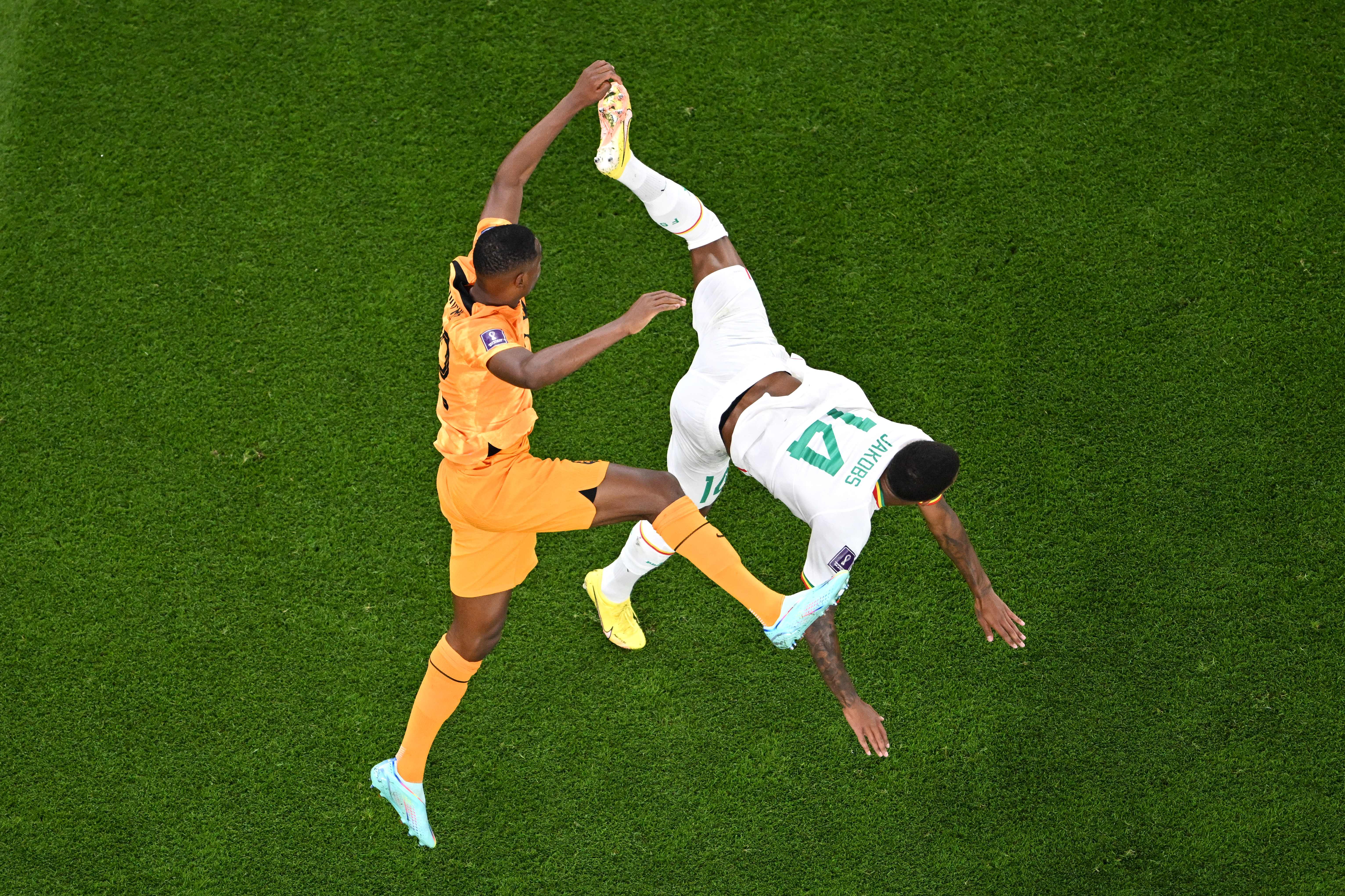 Netherlands’ defender #22 Denzel Dumfries (L) fights for the ball with Senegal’s defender #14 Ismail Jakobs during the Qatar 2022 World Cup Group A football match between Senegal and the Netherlands at the Al-Thumama Stadium in Doha on Nov. 21, 2022.