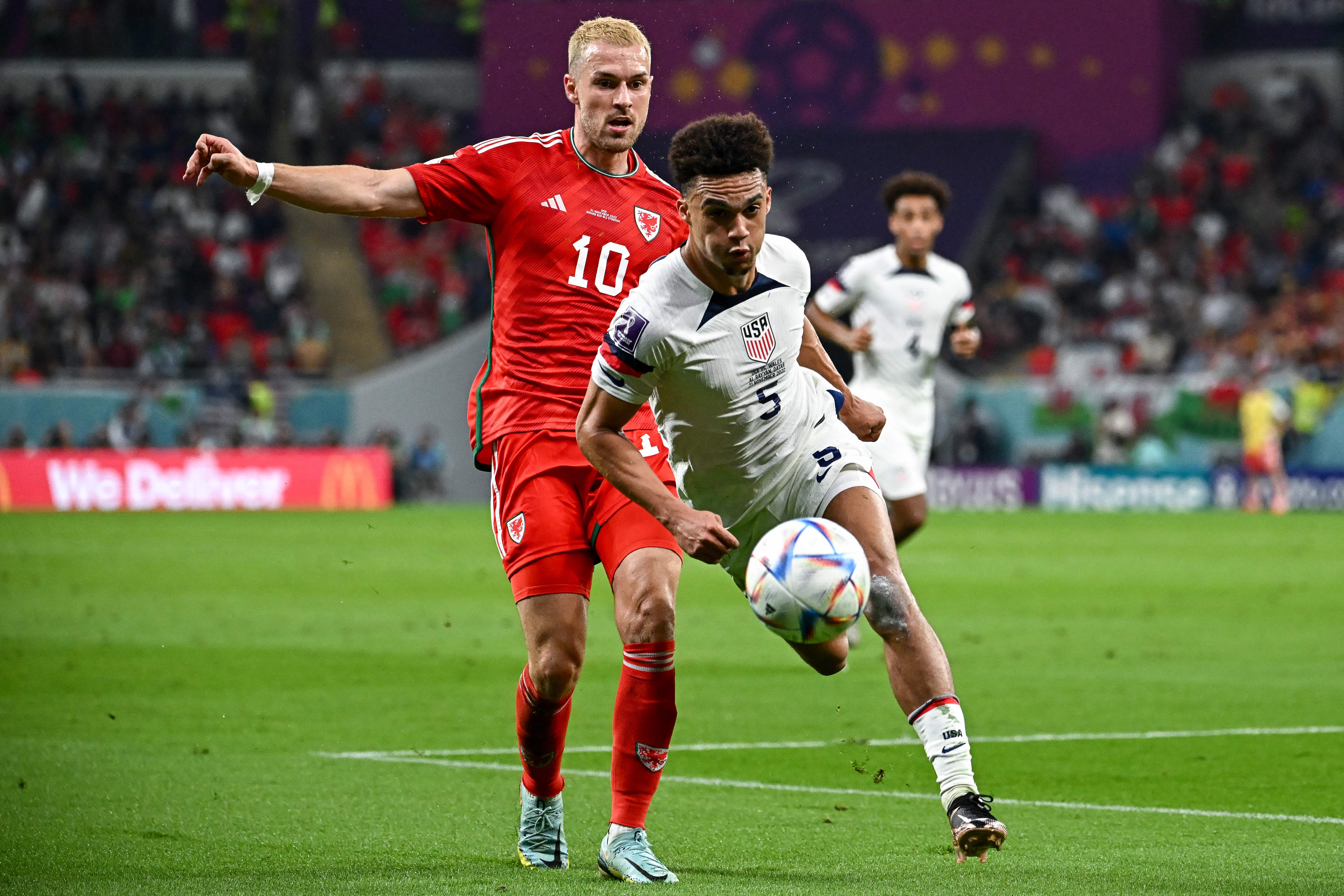 USA’s defender #05 Antonee Robinson (R) fights for the ball with Wales’ midfielder #10 Aaron Ramsey during the Qatar 2022 World Cup Group B football match between USA and Wales at the Ahmad Bin Ali Stadium in Al-Rayyan, west of Doha on Nov. 21, 2022.