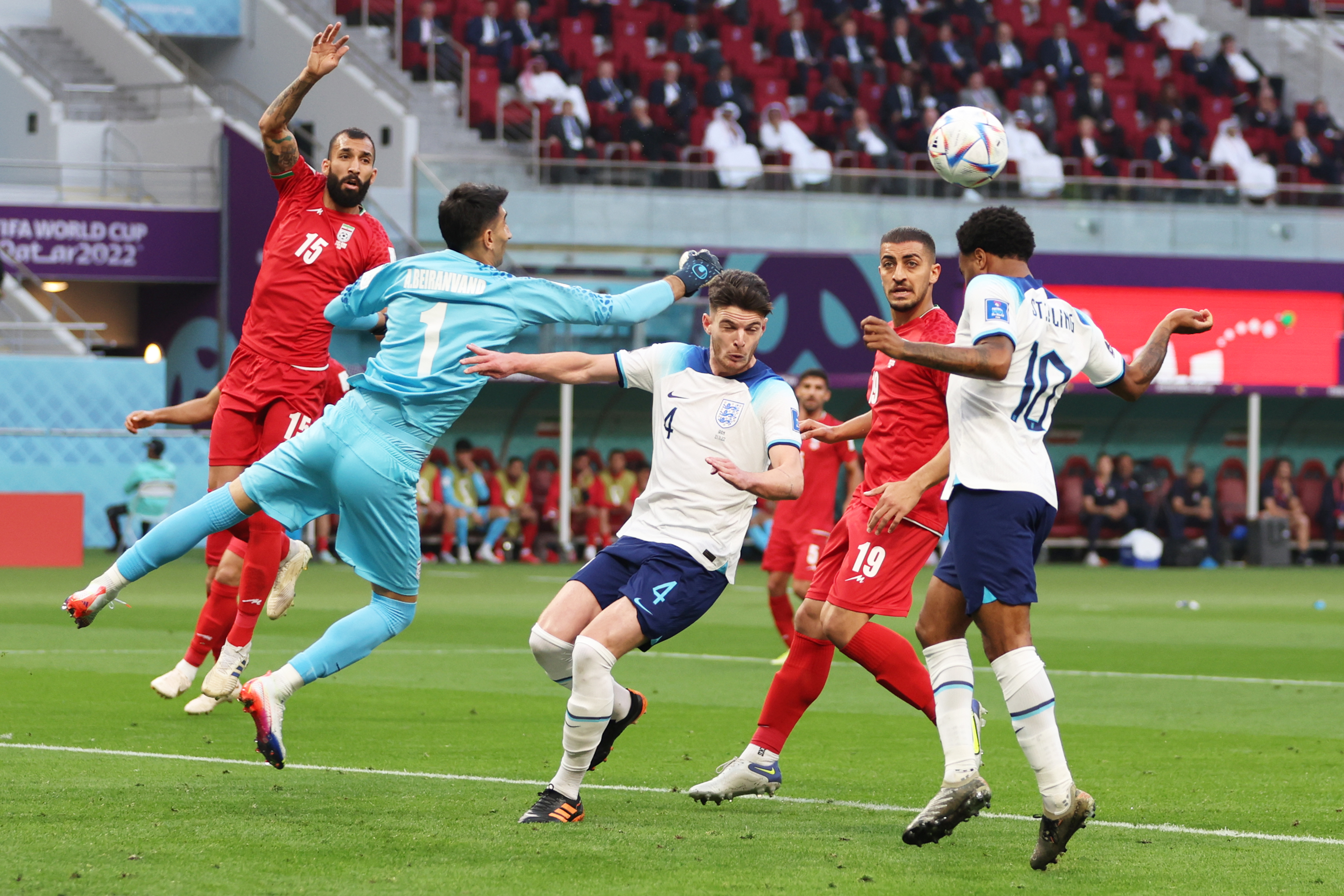 Raheem Sterling of England, right, heads the ball against goalkeeper Alireza Beiranvand of IR Iran during the FIFA World Cup Qatar 2022 Group B match between England and IR Iran at Khalifa International Stadium on Nov. 21, 2022, in Doha, Qatar.