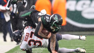 Tyler Conklin #83 of the New York Jets is tackled after making a catch in the second half of a game against the Chicago Bears at MetLife Stadium on November 27, 2022 in East Rutherford, New Jersey. (Photo by Mike Stobe/Getty Images)