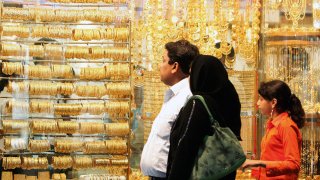 Customers look at the display window of a store at the gold market in Dubai, one of the busiest jewellery markets in the Middle East.