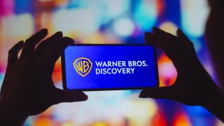 In this photo illustration, the Warner Bros. Discovery logo is displayed on a smartphone screen.