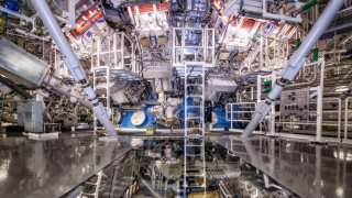 The National Ignition Facility target chamber at the Lawrence Livermore National Laboratory is where scientists shoot lasers and watch and measure what happens when those lasers collide on a fuel source. Temperatures of 100 million degrees and pressures extreme enough to compress a target up to 100 times the density of lead are created in this facility.