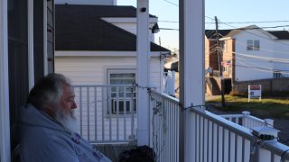 Roger Gendron sits on his porch in Hamilton Beach, Queens. Gendron is one of tens of thousands of residents who live on the far outskirts of Queens in neighborhoods prone to flooding and worsening coastal storms.