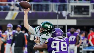 D.J. Wonnum #98 of the Minnesota Vikings hits Mike White #5 of the New York Jets as he attempts a pass during the fourth quarter at U.S. Bank Stadium on December 04, 2022 in Minneapolis, Minnesota. (Photo by Adam Bettcher/Getty Images)