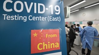 Health workers guide travelers arriving from China through a Covid-19 testing center at Incheon International Airport on Jan. 3, 2023.