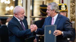 Argentina President Alberto Fernandez (R) and Brazil President Luiz Inacio Lula da Silva (L) greet each other after signing a series of agreements during a news conference in Buenos Aires.