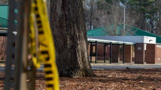 Police tape hangs from a sign post outside Richneck Elementary School following a shooting on Jan. 7, 2023, in Newport News, Virginia.