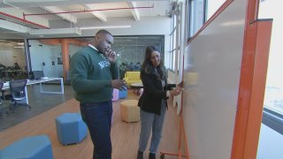 The Marcy Lab School co-founders Reuben Ogbanna and Bhattacharjee-Marcantonio share ideas at the whiteboard.