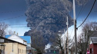 FILE – A black plume rises over East Palestine, Ohio, as a result of a controlled detonation of a portion of the derailed Norfolk Southern trains, Feb. 6, 2023.