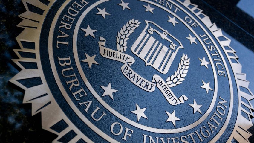 A seal reading “Department of Justice Federal Bureau of Investigation” is displayed on the J. Edgar Hoover FBI building in Washington, DC, on August 9, 2022. (Photo by Stefani Reynolds / AFP)