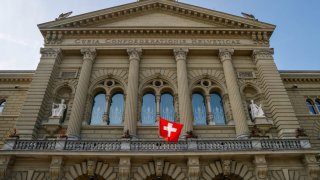 The Swiss national flag at the Federal Palace, Switzerland’s parliament building, in Bern, Switzerland, on Thursday, June 17, 2021.