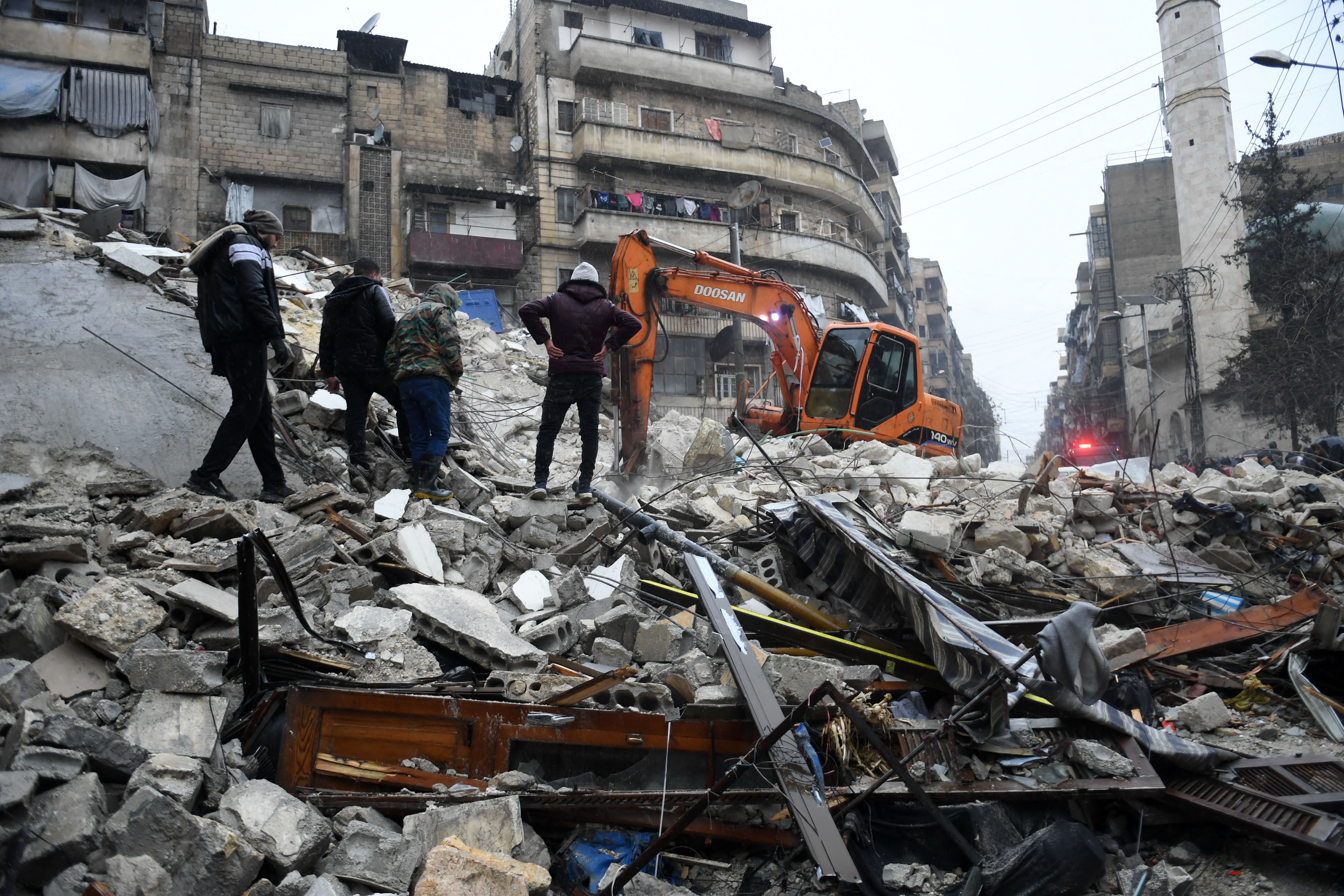 Rescue teams search for survivors under the rubble of a collapsed building in Aleppo, Syria, Feb. 6, 2023.