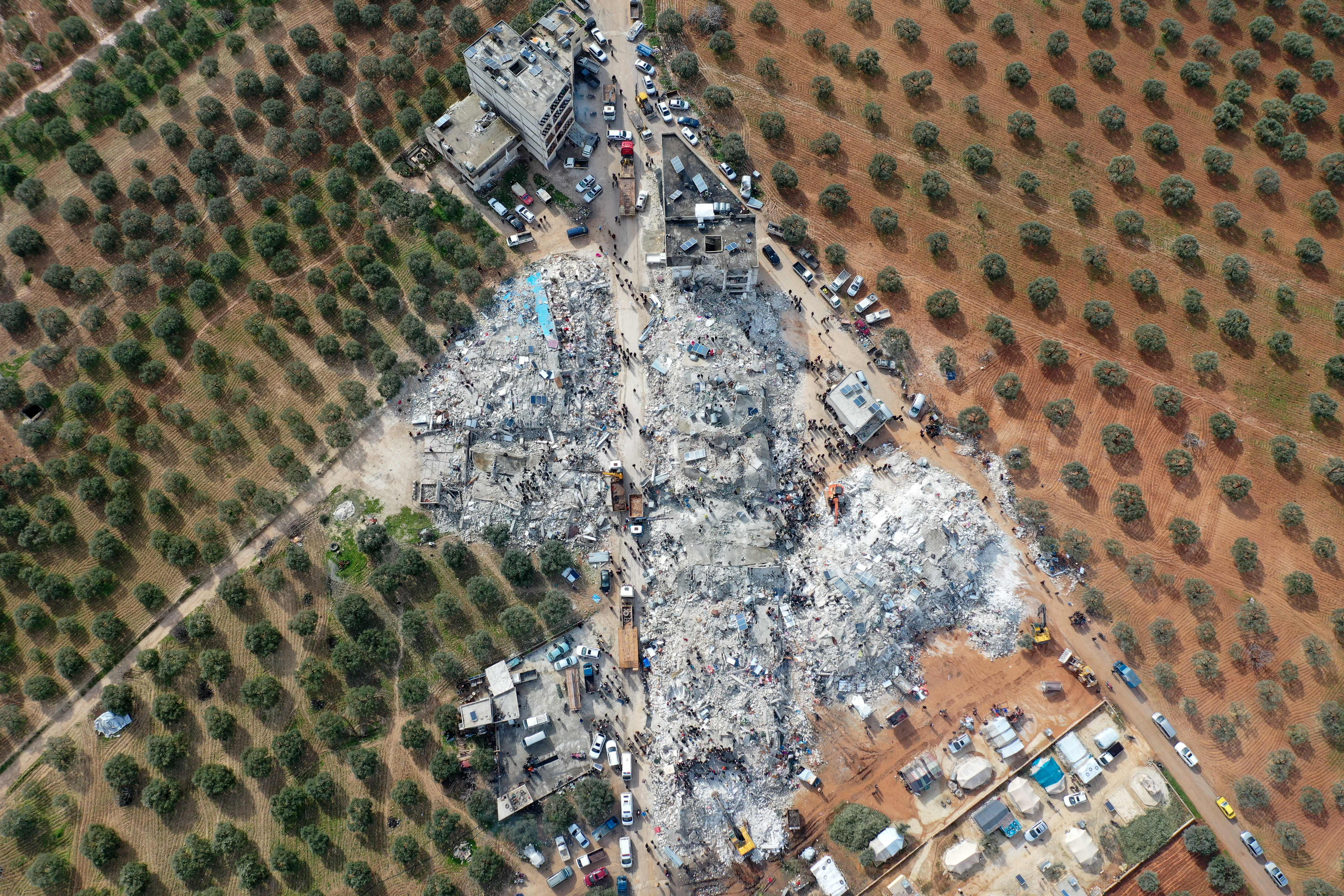 Residents search for victims and survivors amidst the rubble of collapsed buildings in the village of Besnia, Syria, Feb. 6, 2022. The village is close to the Turkish-Syrian border, where a 7.8 magnitude – and later<br />
 a 7.5 magnitude – earthquake struck.