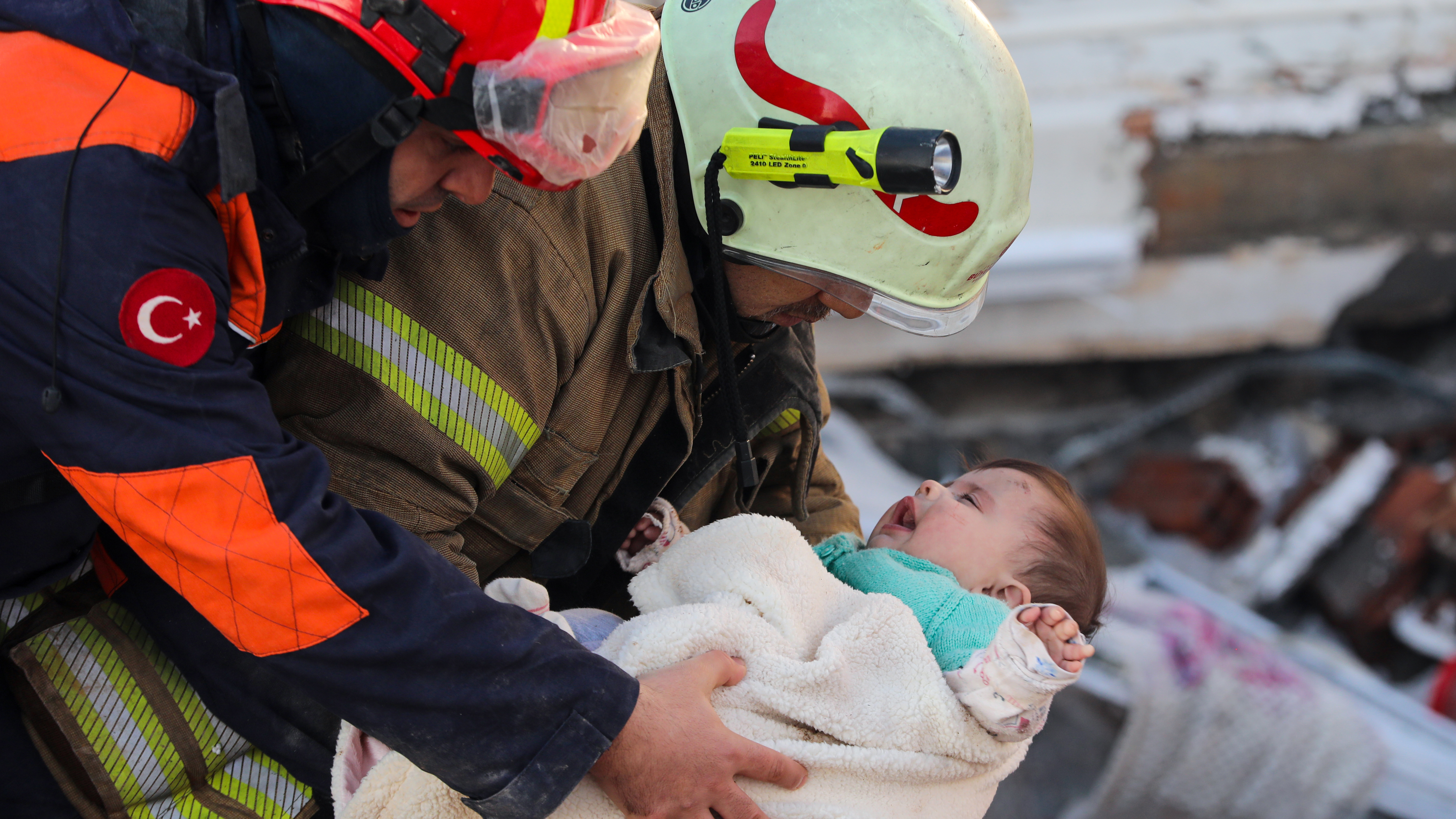 Baby Ayse Vera and her mother, Hulya Yilmaz (not pictured), are rescued from the rubble of a collapsed building, 29 hours after powerful earthquakes hit Hatay, Turkey, Feb. 7, 2023.