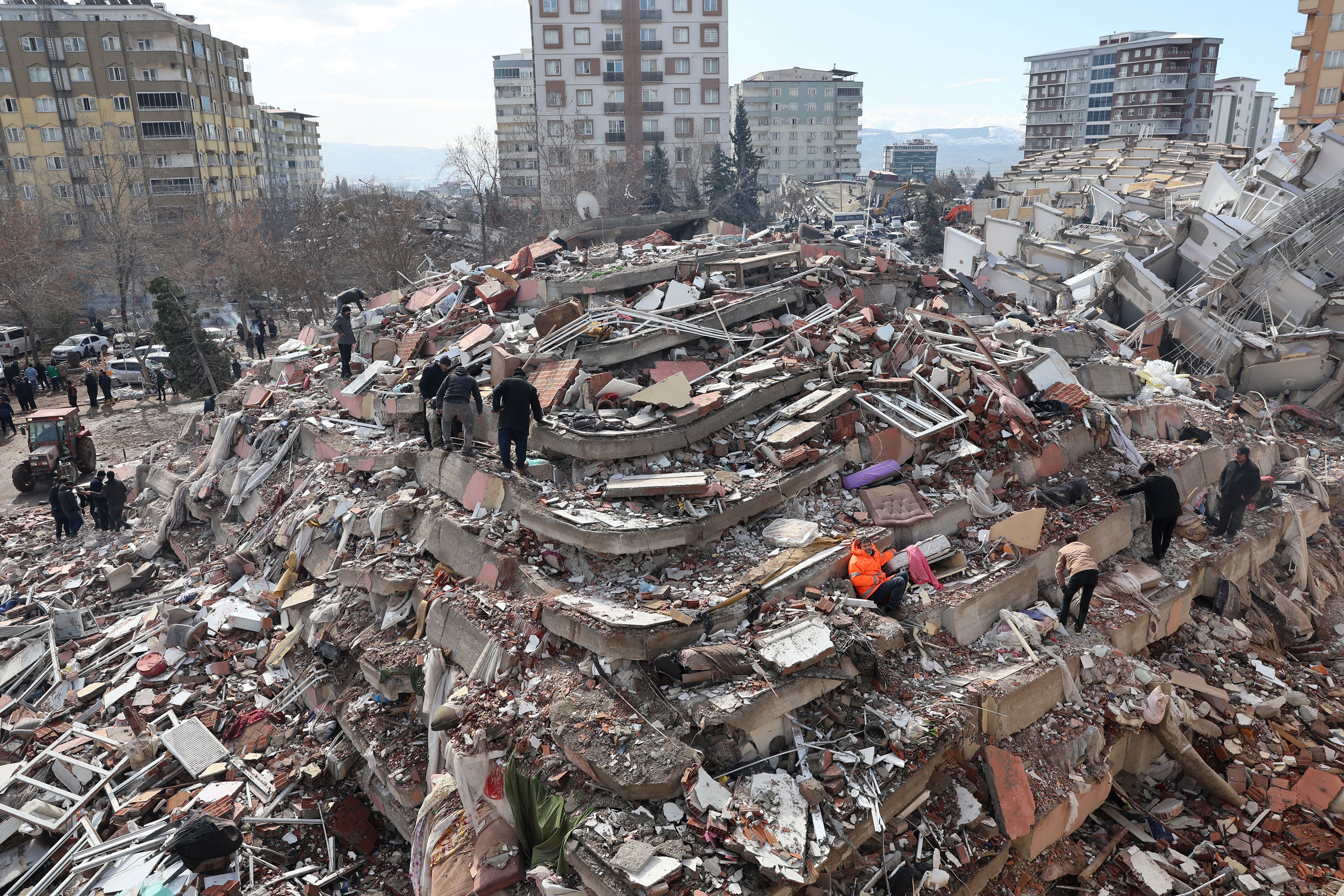 Civilians look for survivors under the rubble of collapsed buildings in Kahramanmaras on Feb. 7, 2023, the day after a 7.8-magnitude earthquake struck the country’s southeast border with Syria.