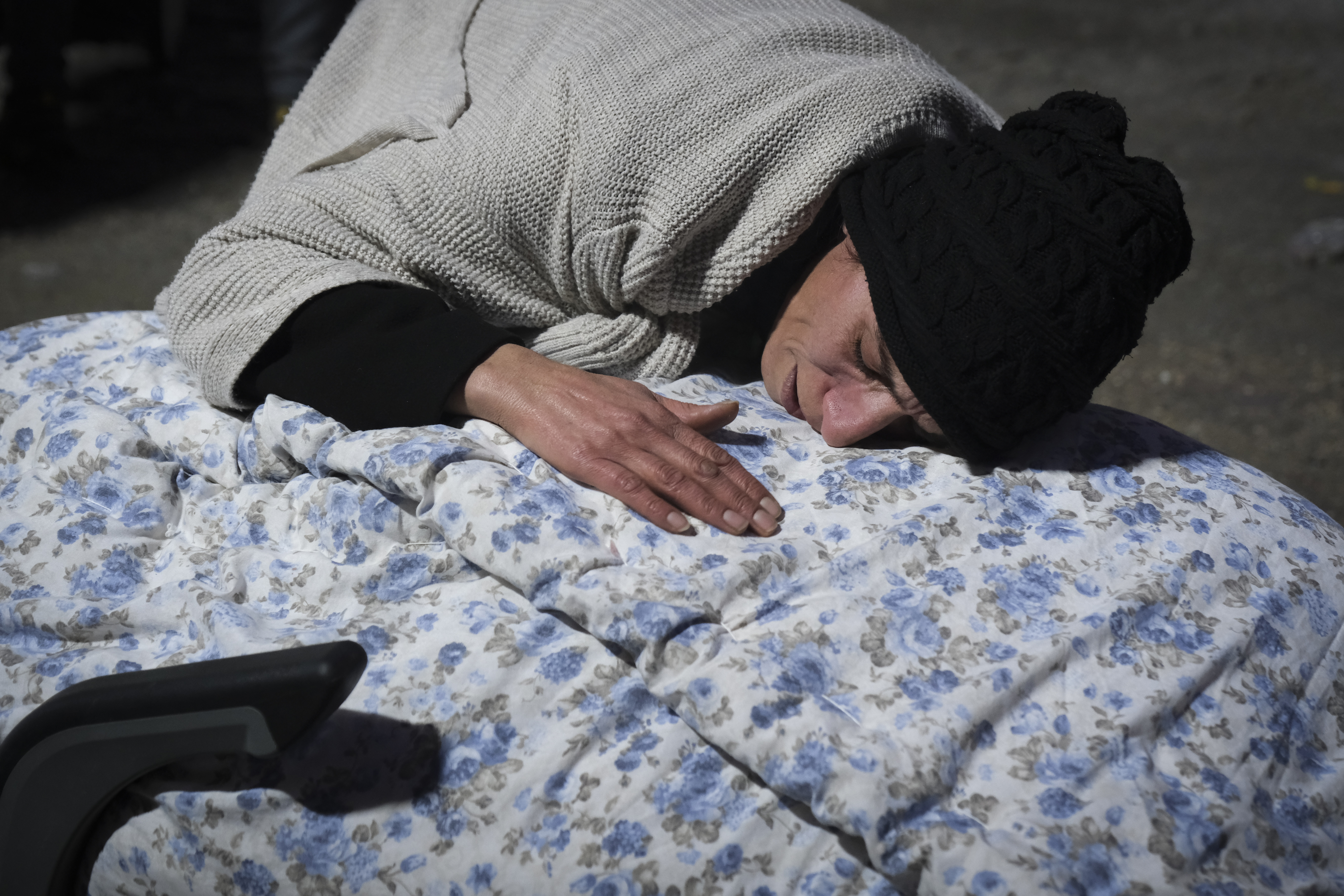 A woman cries as she waits for the autopsy to be carried out on her aunt, in front of the Elbistan State Hospital, Feb. 8, 2023, in Elbistan Turkey. The massive 7.8 earthquake that struck Turkey and Syria devastated the area, leveling towns and killing thousands of people as they slept early Monday morning.