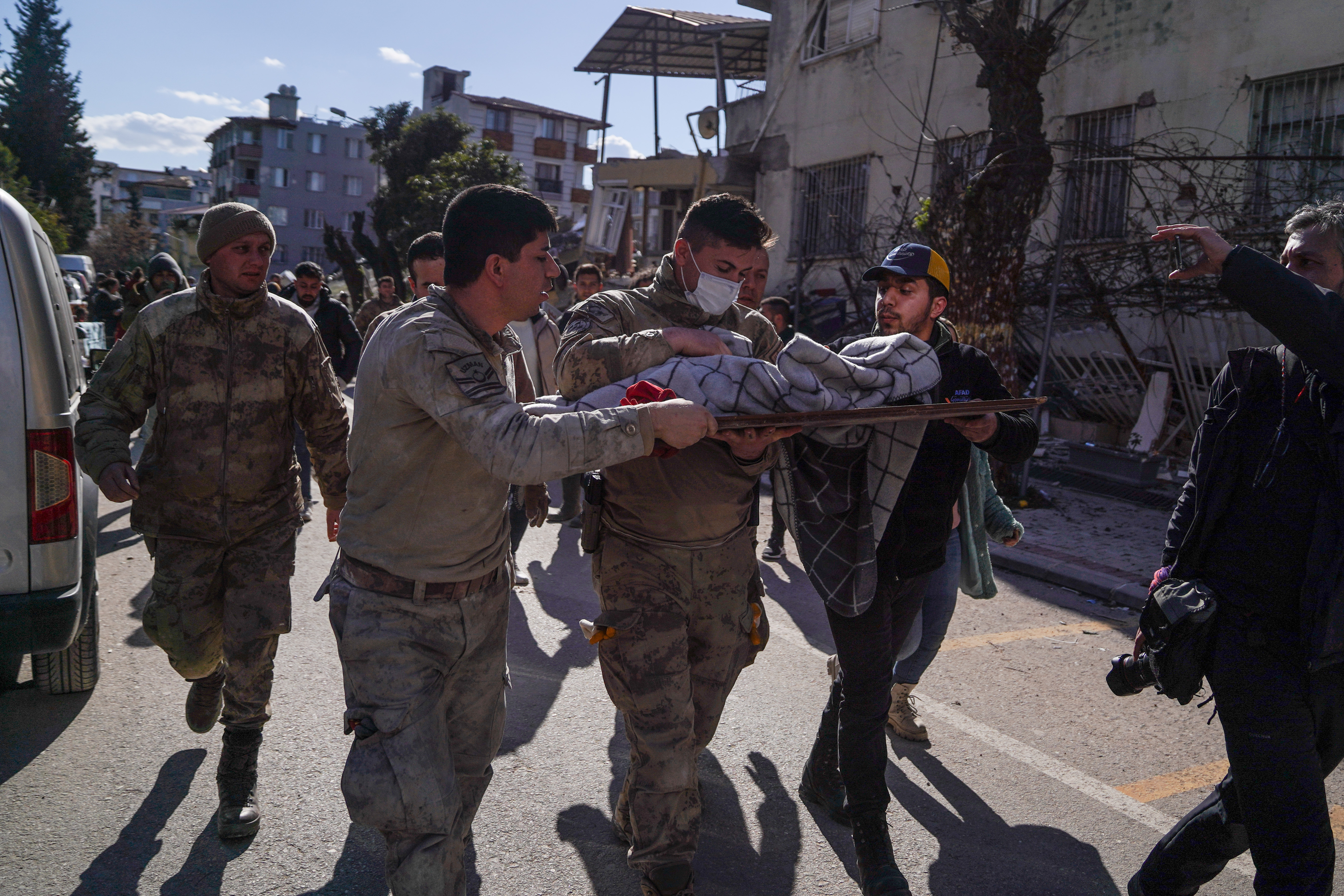 Soldiers rush a newborn to an ambulance for medical treatment in Hatay, Turkey, Feb. 8, 2023. The newborn, 20-days old, was rescued 59 hours after the earthquake and reported to be in good health. Rescue efforts continue for his mother.