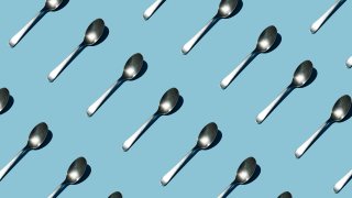 Seamless pattern of teaspoon on blue background