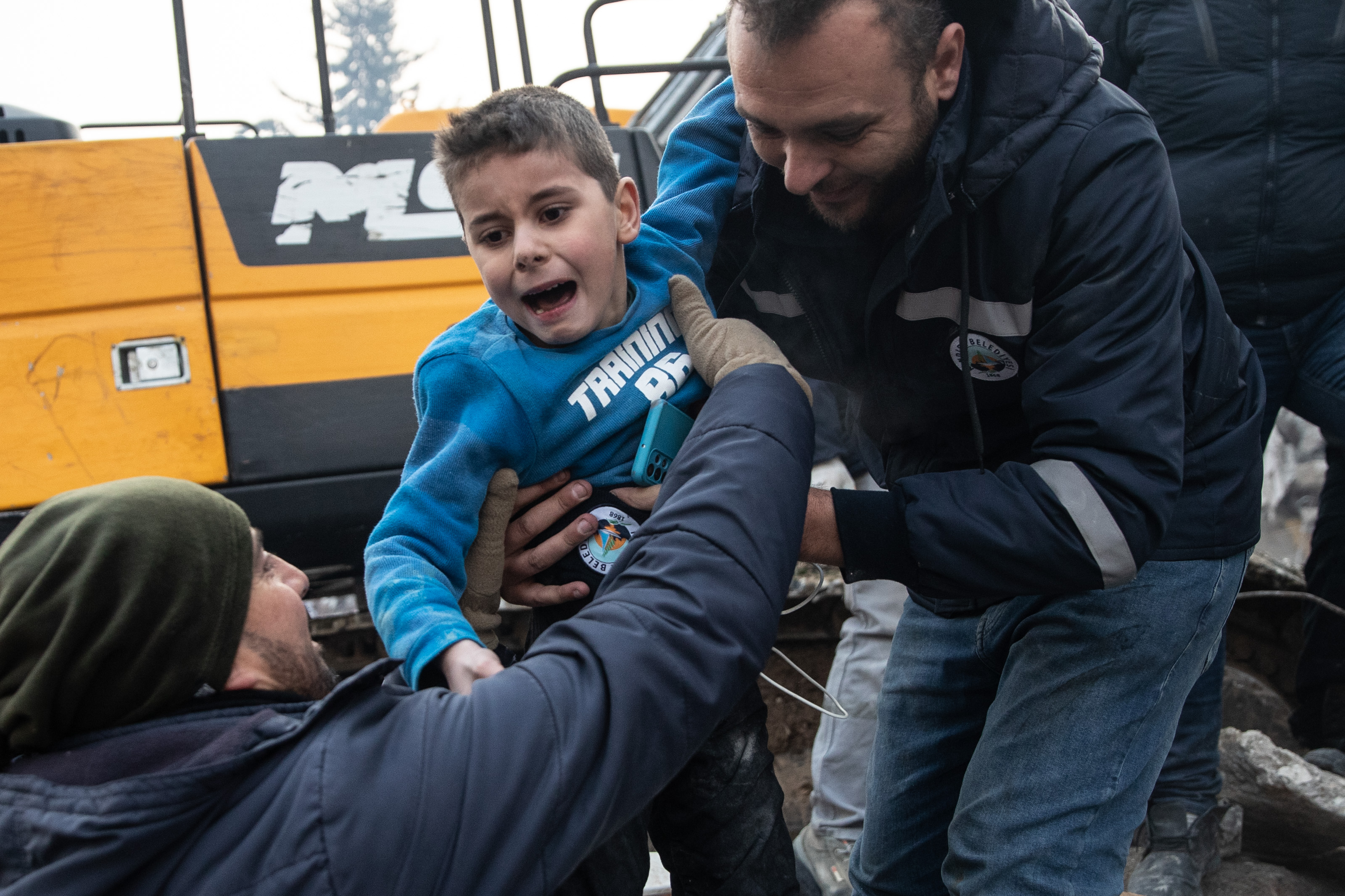 Rescue workers carry Yigit Cakmak, an 8-years-old survivor at the site of a collapsed building 52 hours after the earthquake struck, on Feb. 8, 2023, in Hatay, Turkey. A 7.8-magnitude earthquake hit near Gaziantep, Turkey, in the early hours of Monday, followed by another 7.5-magnitude tremor just after midday. The quakes caused widespread destruction in southern Turkey and northern Syria and were felt in nearby countries.