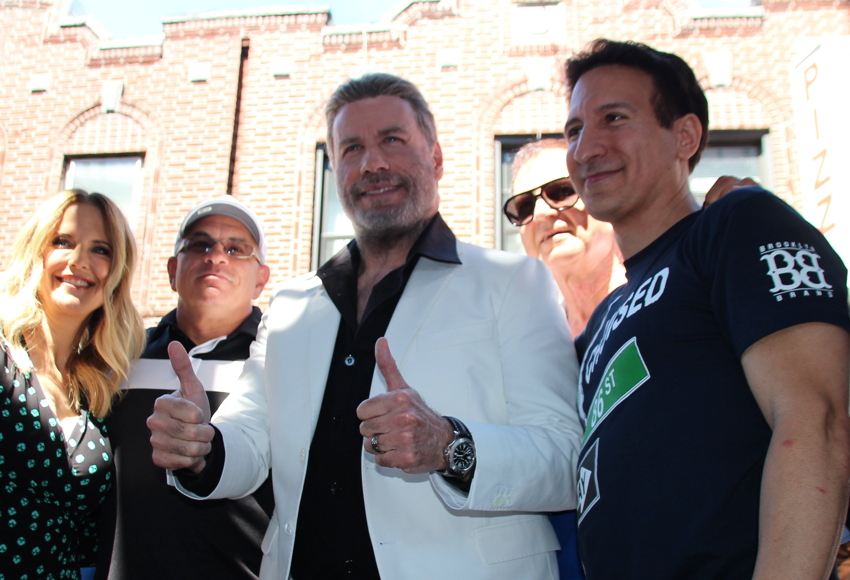 Hollywood star John Travolta and his wife, actress Kelly Preston, celebrate in front of the food stall "Lenny's Pizza" on 86th Street in Bensonhurst with colleagues and numerous fans.