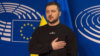 Ukrainian President Volodymyr Zelenskyy stands while listening to the Ukrainian national anthem on his arrival at the European Parliament on February 09, 2023 in Brussels, Belgium.