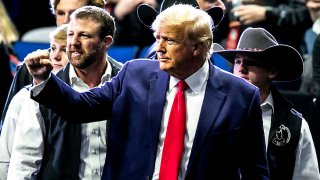 Former U.S. President Donald Trump greets fans as he arrives before the finals during the sixth session of the NCAA Division I Wrestling Championships at BOK Center in Tulsa, Oklahoma, U.S. March 18, 2023. 