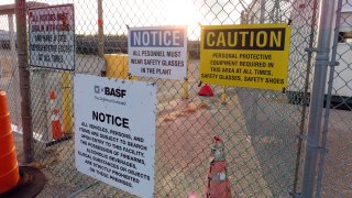 A gate at the entrance to the former Ciba Geigy chemical plant in Toms River,N.J., is filled with warning, Jan. 24, 2023, regarding the contaminated area, which is on the Superfund list of the nation's worst toxic waste sites.