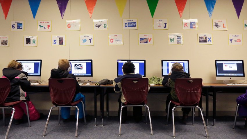 Watford City Elementary School students use computers in a portable building in Watford City, N.D., Dec. 17, 2014.