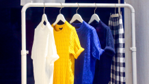 A garment rack sits outside of the closet and holds your excess clothes.