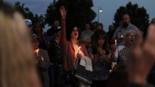 Community members sing during a prayer vigil at Hills Church, Monday, May 15, 2023, in Farmington, N.M. Authorities said an 18-year-old man roamed through the community firing randomly at cars and houses Monday, killing three people and injuring six others including two police officers before he was killed. (AP Photo/Susan Montoya Bryan)