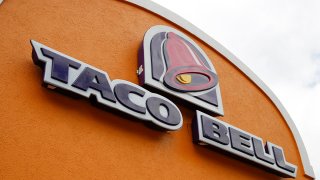 FILE - A sign hangs at a Taco Bell on May 23, 2014, in Mount Lebanon, Pa.
