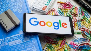 In this photo illustration a Google logo seen displayed on a smartphone.