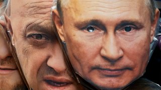 Face masks depicting Russian President Vladimir Putin, right, and owner of private military company Wagner Group Yevgeny Prigozhin are displayed among others for sale at a souvenir shop in St. Petersburg, Russia, Sunday, June 4, 2023.