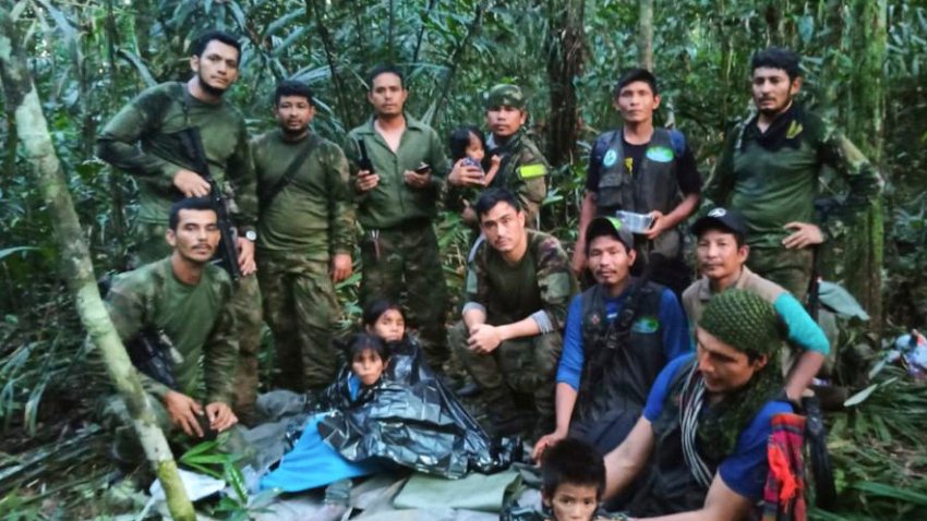 In this photo released by Colombia’s Armed Forces Press Office, soldiers and Indigenous men pose for a photo with the four Indigenous brothers who were missing after a deadly plane crash, in the Solano jungle, Caqueta state, Colombia, Friday, June 9, 2023. Colombian President Gustavo Petro said Friday that authorities found alive the four children who survived a small plane crash 40 days ago and had been the subject of an intense search in the Amazon jungle.